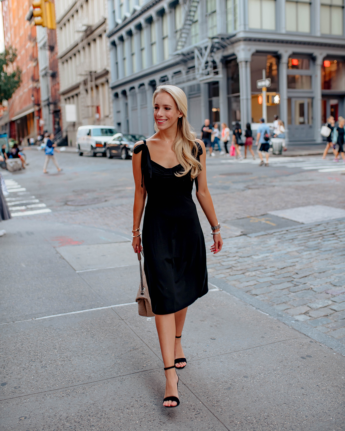 Blonde Woman Wearing Reformation Black Dress Tan Ankle Strap